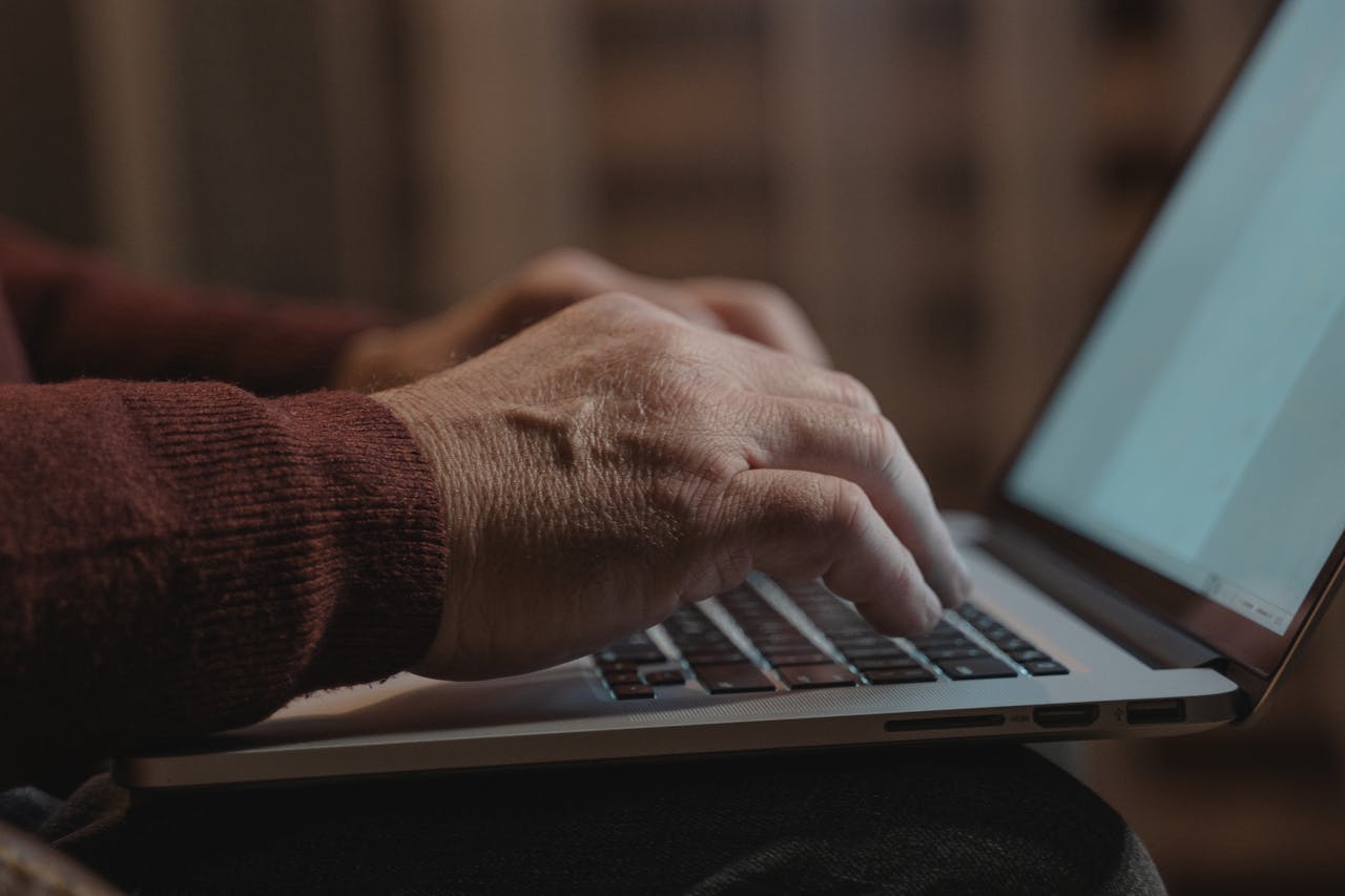 Close-up of hands typing on a laptop keyboard, ideal for business and technology themes.